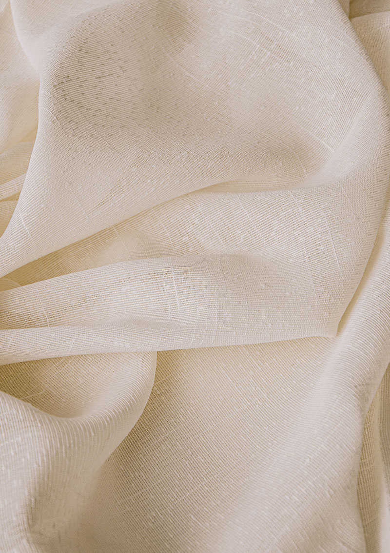 Close-up of BORN Cream curtain bouclé fabric showing its weave.