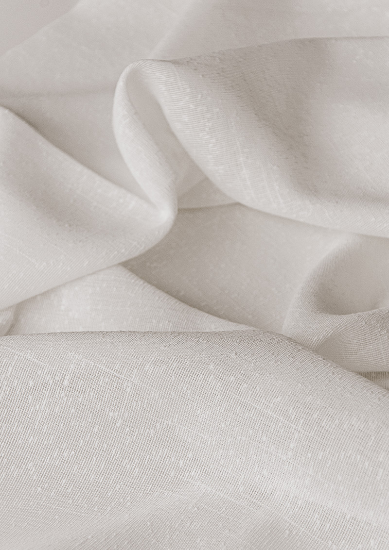 Close-up of BORN White curtain bouclé fabric showing its weave.