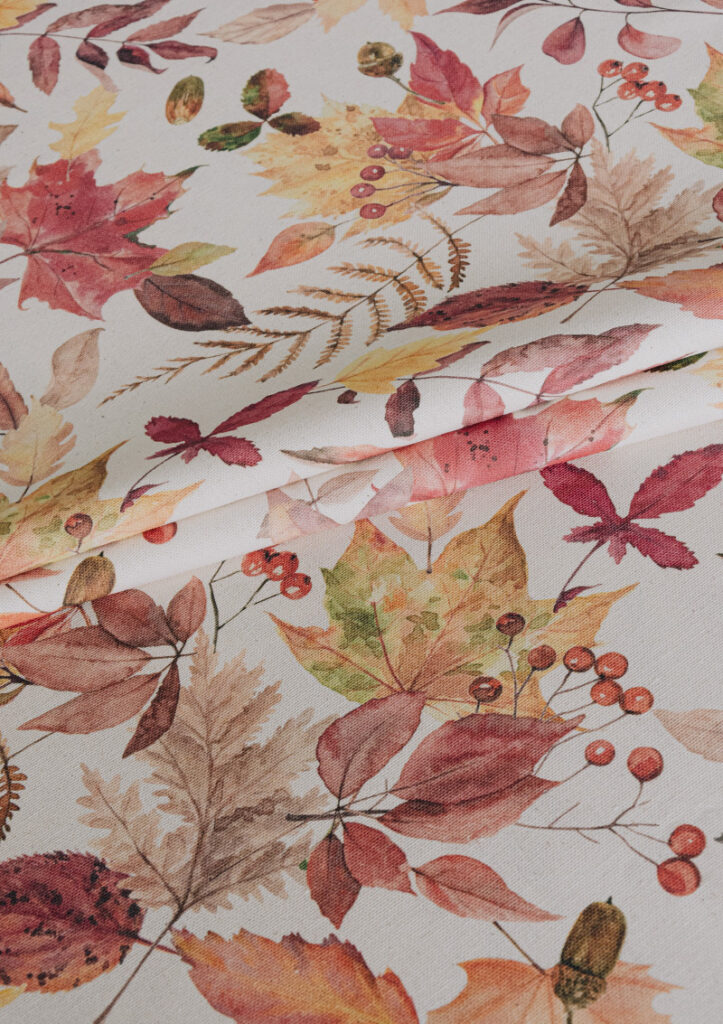 Fabric detail of OYAMEL, featuring a dynamic leaf pattern in brick red, amber, and soft browns.