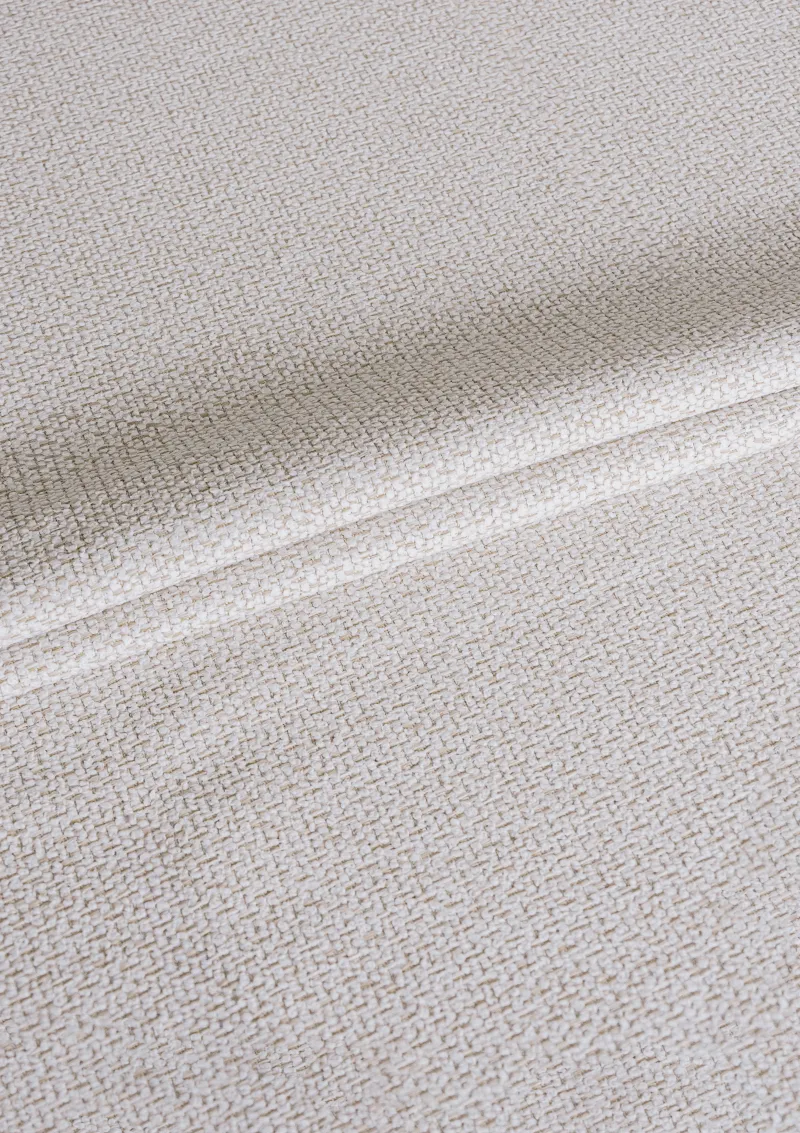 Close-up of Alika outdoor fabric showing textured weave and water-repellent finish in a solid color.