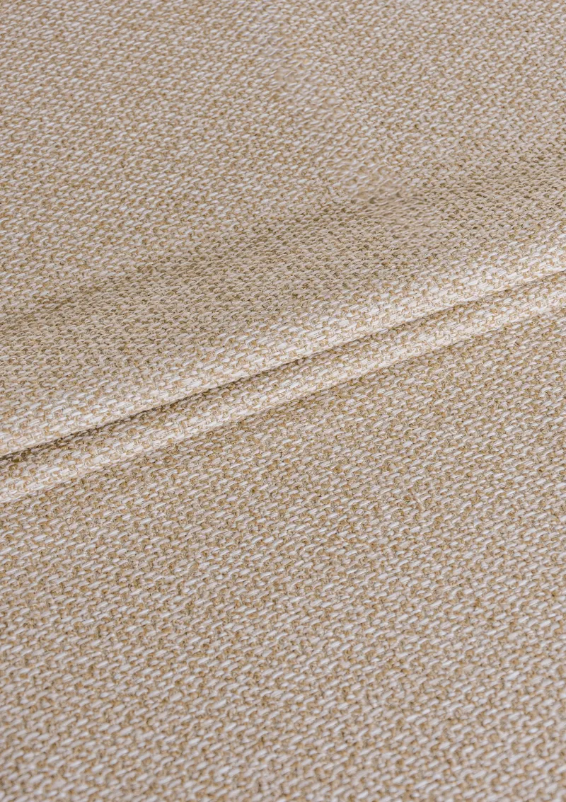 Close-up of Alika outdoor fabric showing textured weave and water-repellent finish in a solid color.