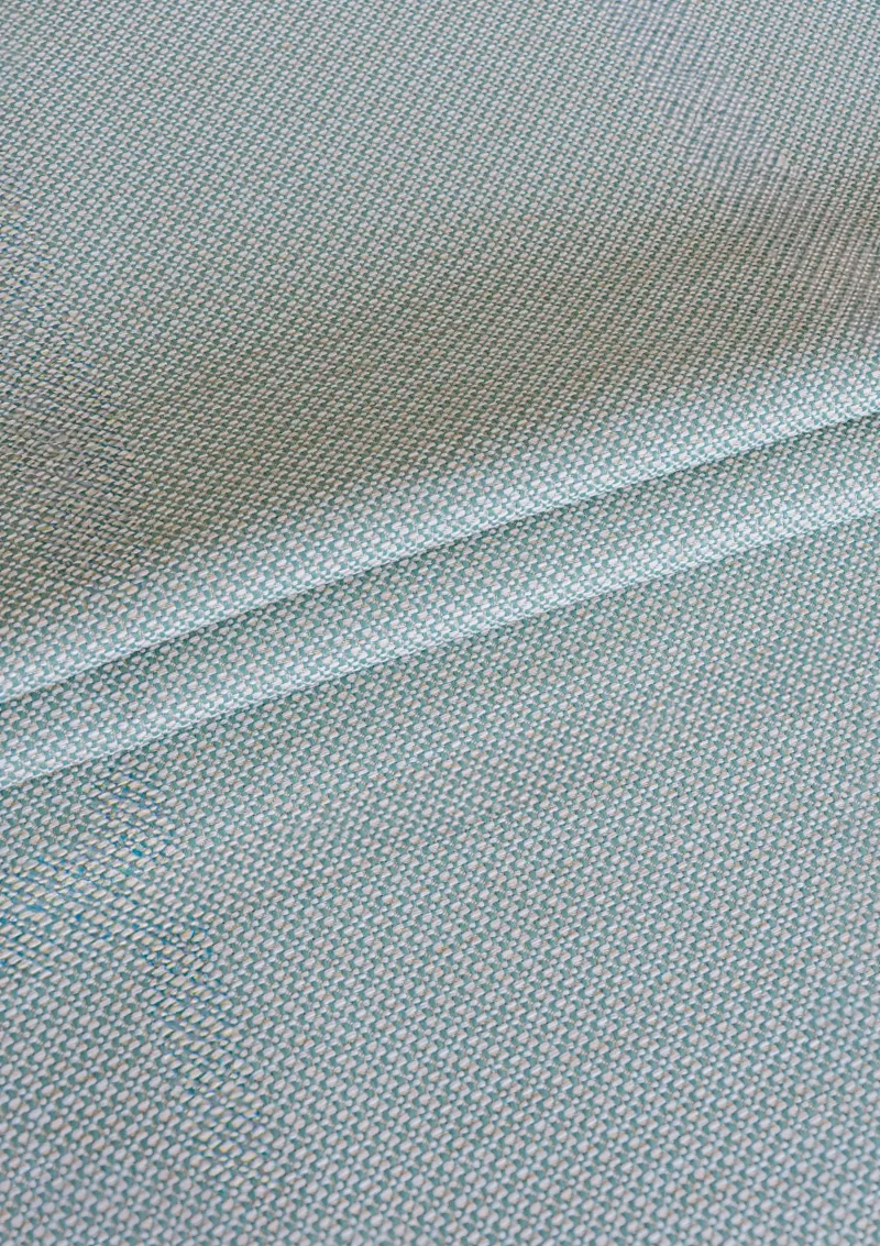 Zoomed-in view of Azuria outdoor fabric highlighting fine texture, color depth, and water-repellent surface. Acqua color