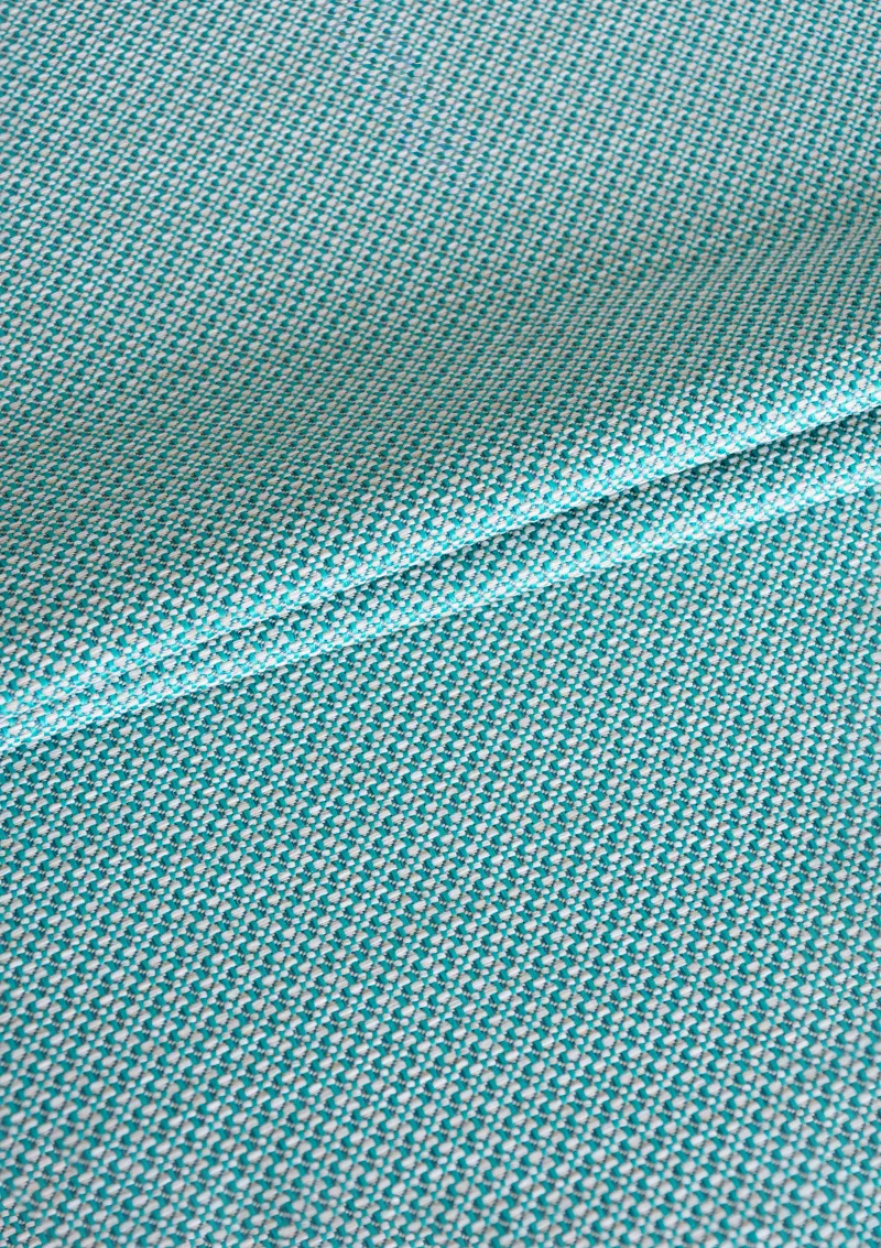 Zoomed-in view of Azuria outdoor fabric highlighting fine texture, color depth, and water-repellent surface. Turquose color