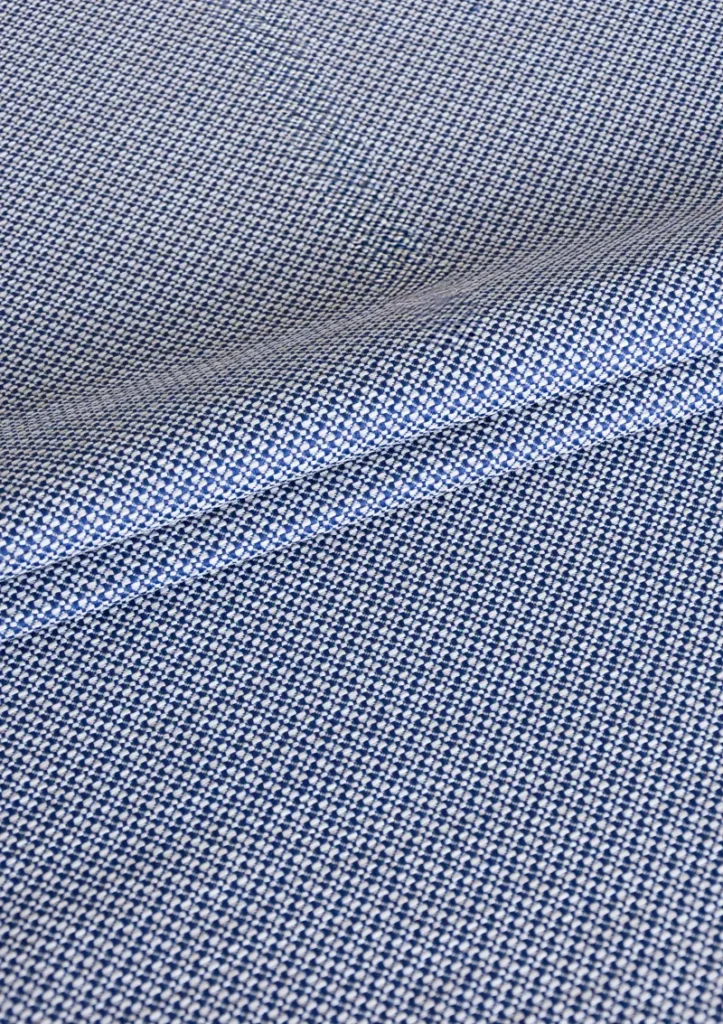 Zoomed-in view of Azuria outdoor fabric highlighting fine texture, color depth, and water-repellent surface. Blue navy color